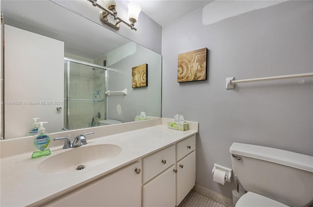 bathroom with tile patterned flooring, vanity, toilet, and an enclosed shower