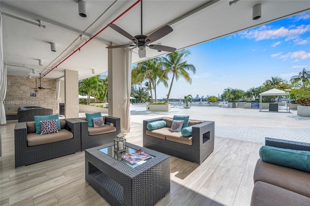 exterior space featuring outdoor lounge area and ceiling fan