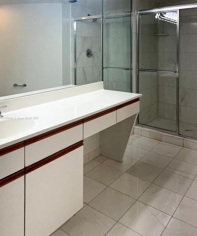 bathroom featuring vanity, tile patterned flooring, and a shower with shower door