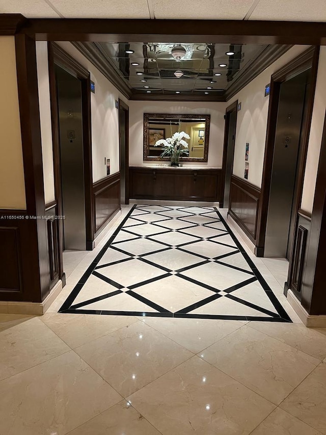 corridor featuring ornamental molding and a drop ceiling