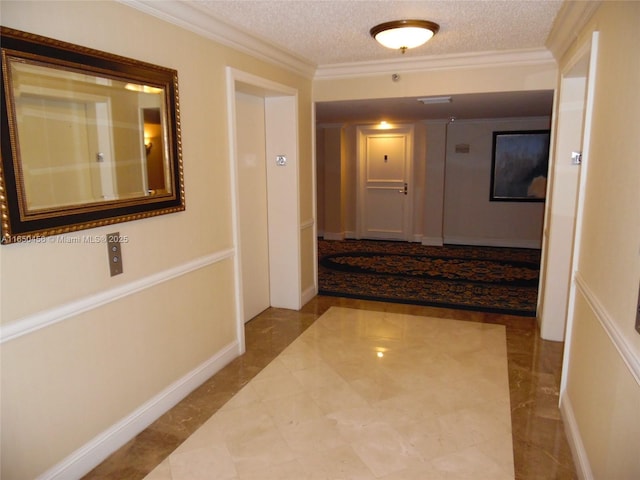 hall with ornamental molding and a textured ceiling