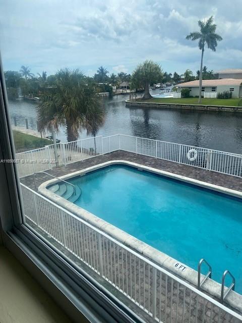 view of swimming pool with a water view