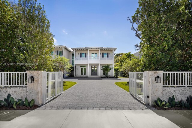 view of front of home featuring a balcony and french doors