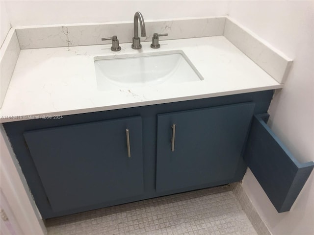 bathroom with tile patterned flooring and vanity