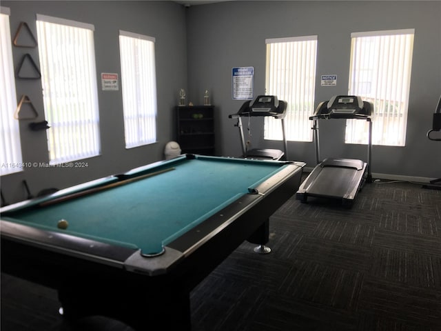 game room with billiards, a healthy amount of sunlight, and dark colored carpet