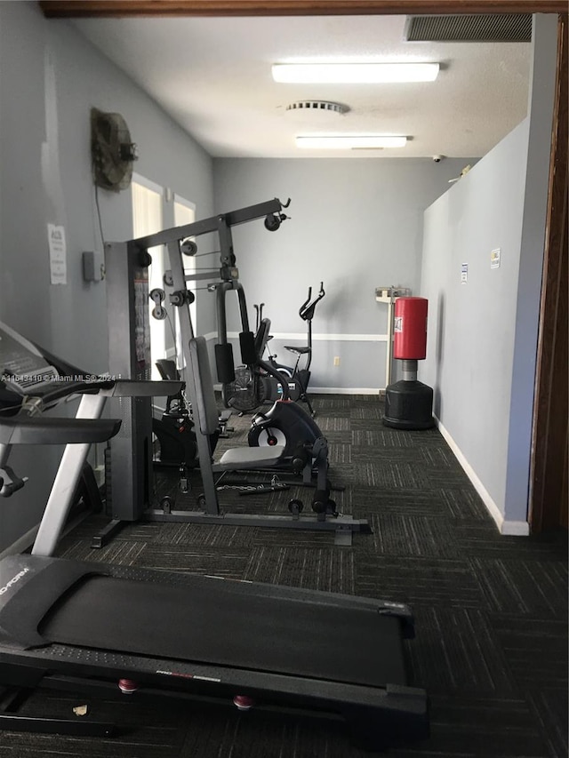 workout area with dark colored carpet