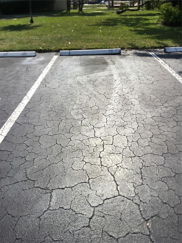 view of vehicle parking featuring a yard