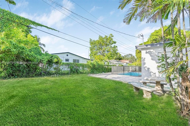 view of yard with a fenced in pool