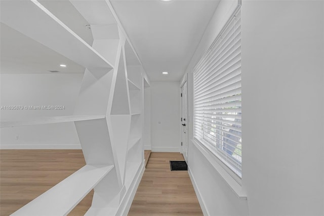 walk in closet featuring light hardwood / wood-style flooring