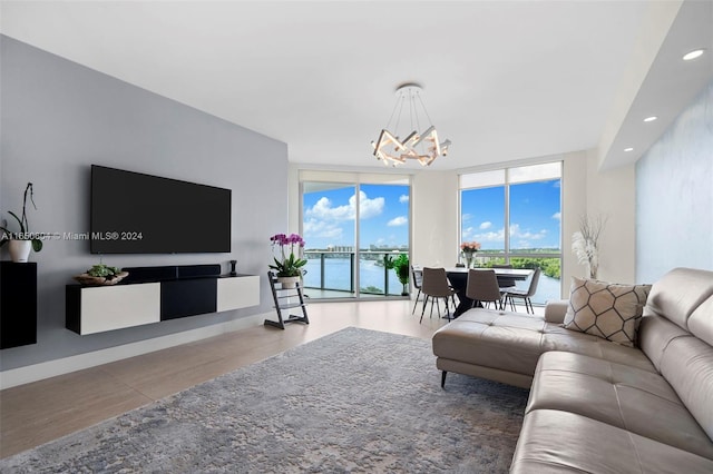 living room with floor to ceiling windows, light hardwood / wood-style floors, and a notable chandelier