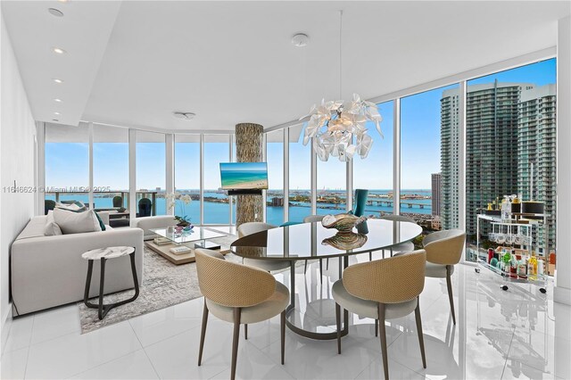 dining space with expansive windows and a chandelier