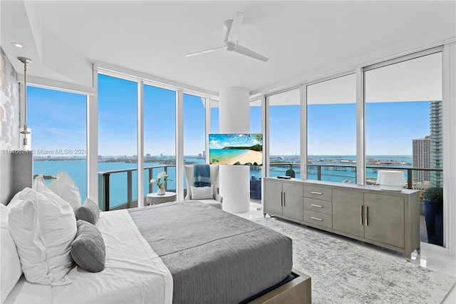 bedroom with floor to ceiling windows, ceiling fan, and multiple windows