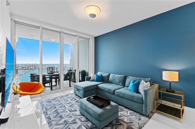 living room featuring a wall of windows and a water view