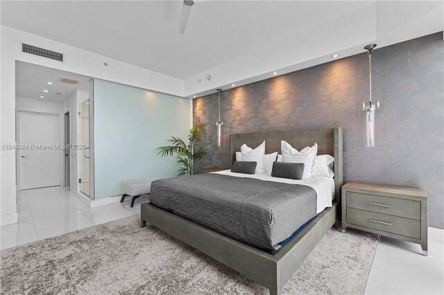 tiled bedroom with ceiling fan and expansive windows