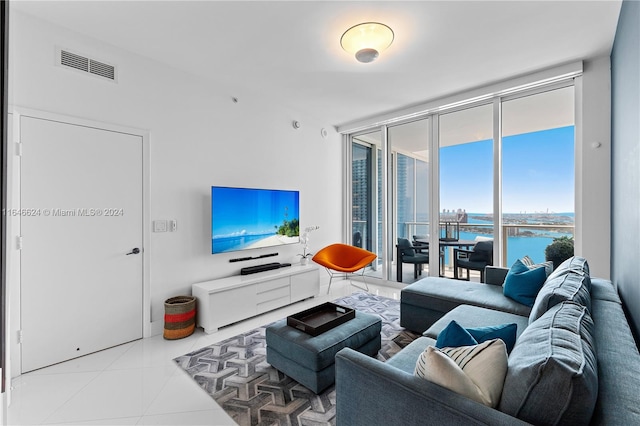 living room featuring expansive windows and light tile patterned floors