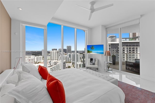 bedroom featuring expansive windows and ceiling fan