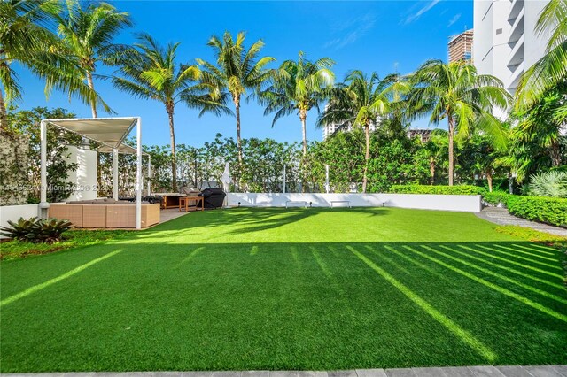 exterior space featuring an outdoor living space, a lawn, and a grill