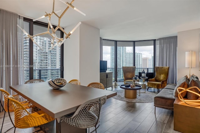 dining space with hardwood / wood-style floors and a wall of windows