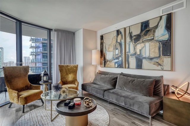 living room with hardwood / wood-style floors and expansive windows