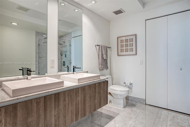 bathroom with toilet, vanity, and walk in shower