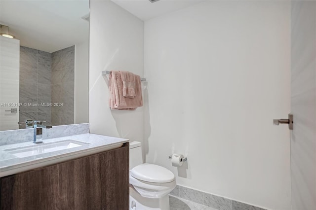 bathroom featuring tile patterned floors, vanity, and toilet