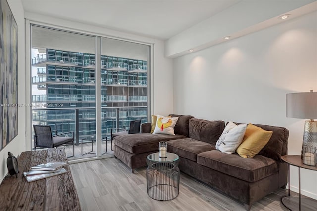 living room with hardwood / wood-style flooring and floor to ceiling windows