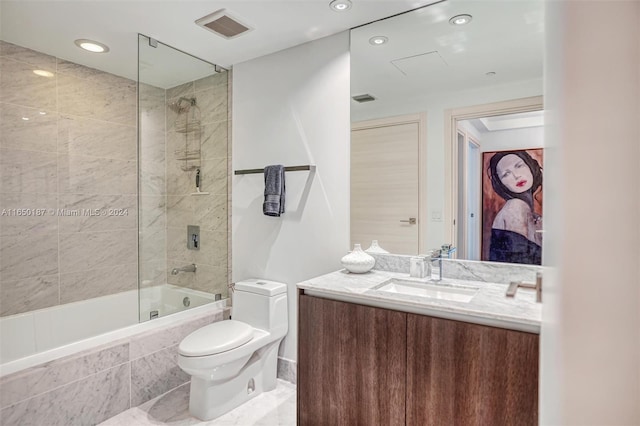 full bathroom with vanity, tiled shower / bath combo, and toilet