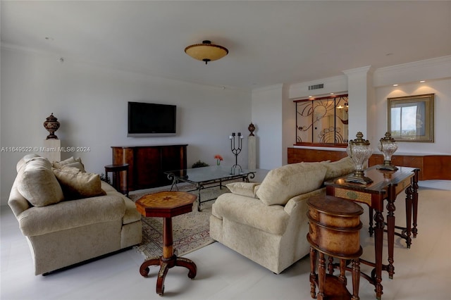 living room with decorative columns and ornamental molding