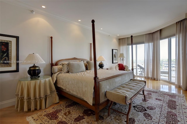 bedroom featuring ornamental molding, access to exterior, and light hardwood / wood-style flooring