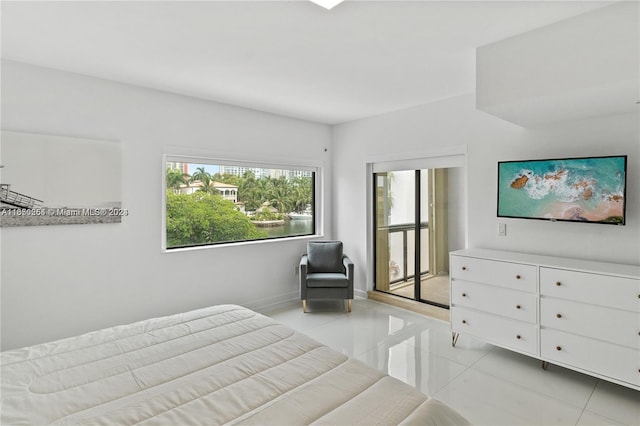 bedroom with light tile patterned floors and baseboards