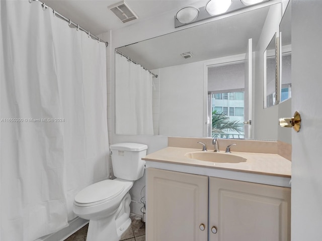 bathroom with vanity, toilet, a shower with shower curtain, and tile patterned flooring