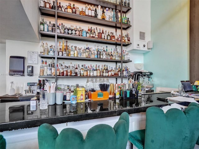 bar featuring dark stone countertops