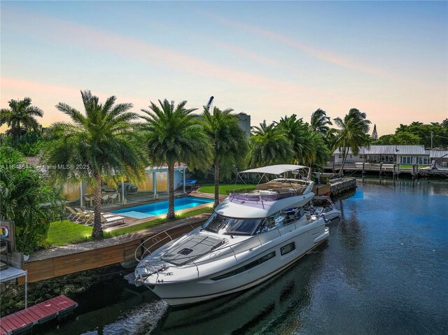 view of dock featuring a patio and a water view