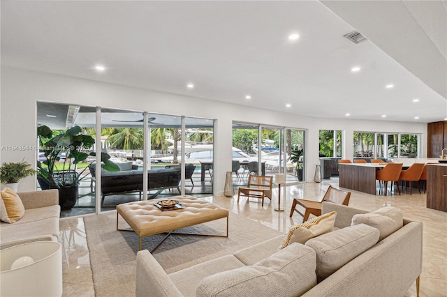 living room featuring recessed lighting and visible vents