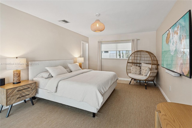 carpeted bedroom featuring baseboards and visible vents