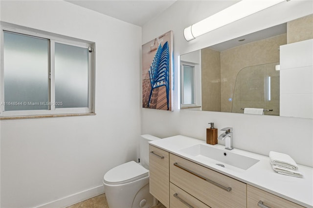 bathroom with baseboards, toilet, tile patterned flooring, walk in shower, and vanity