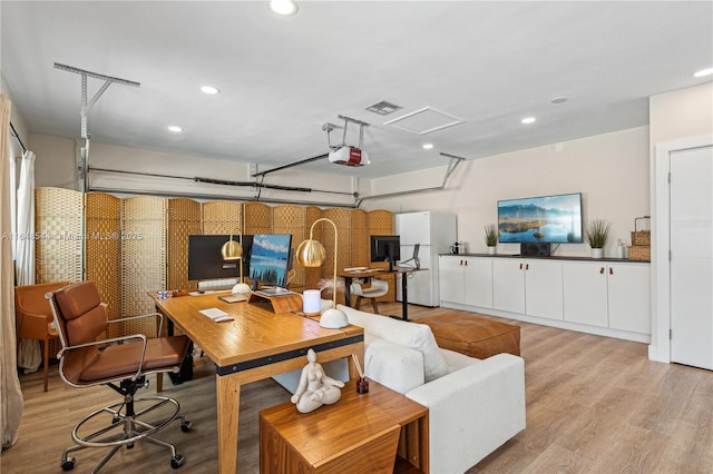 interior space with light wood finished floors, visible vents, and recessed lighting