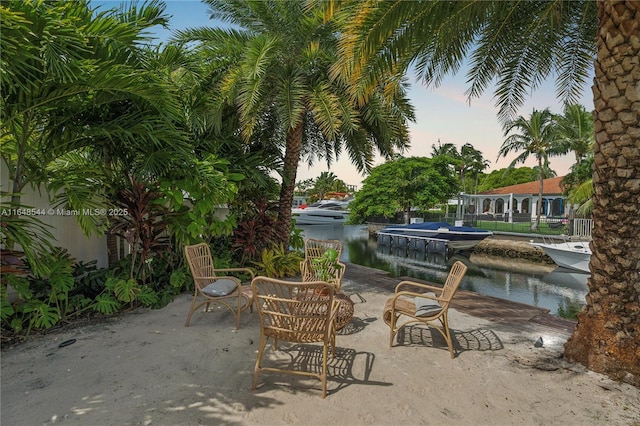 view of patio / terrace featuring a water view and a dock