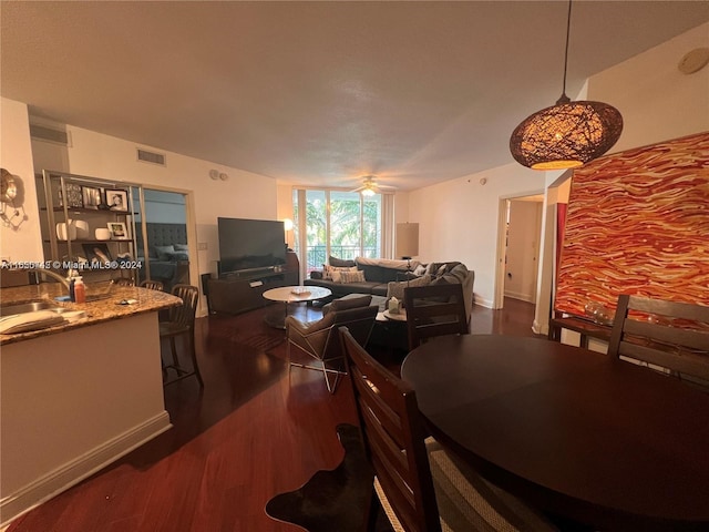 dining room with dark hardwood / wood-style flooring and sink