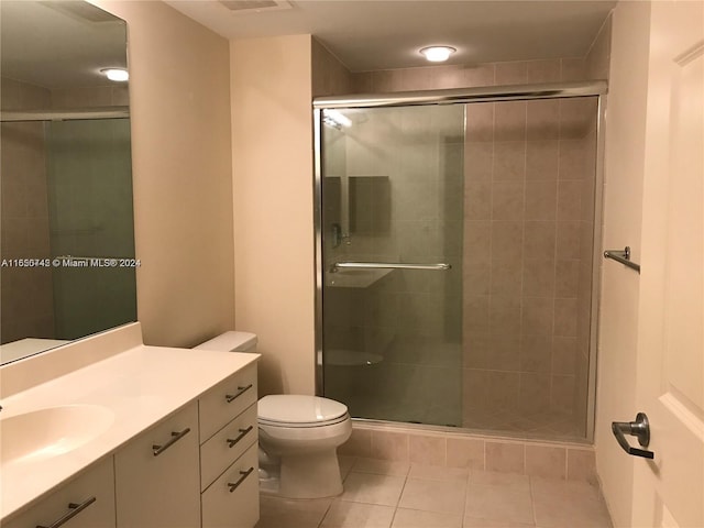 bathroom featuring vanity, toilet, tile patterned floors, and walk in shower