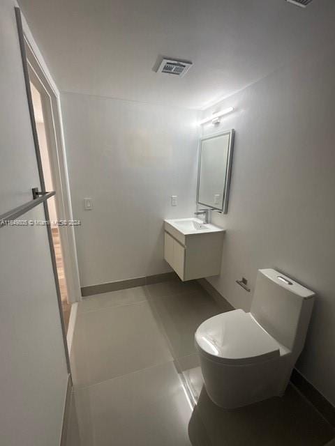 bathroom with toilet and tile patterned floors