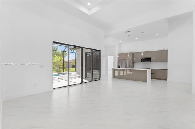 interior space with a high ceiling and sink