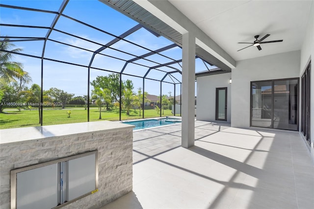 view of patio featuring ceiling fan and a lanai