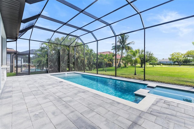 view of swimming pool with a yard, a patio area, and glass enclosure