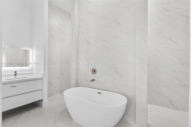 bathroom featuring vanity, independent shower and bath, and tile walls