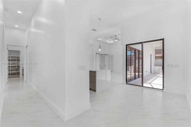 hallway featuring a towering ceiling