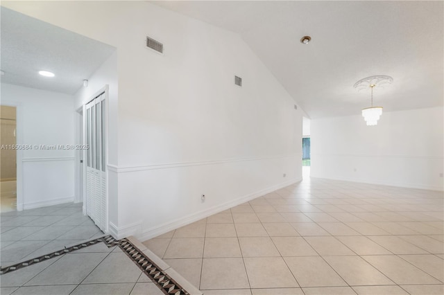 unfurnished room featuring light tile patterned floors, baseboards, and visible vents