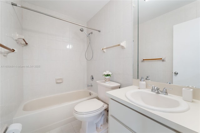 bathroom featuring toilet, tile patterned floors, vanity, shower / washtub combination, and tile walls