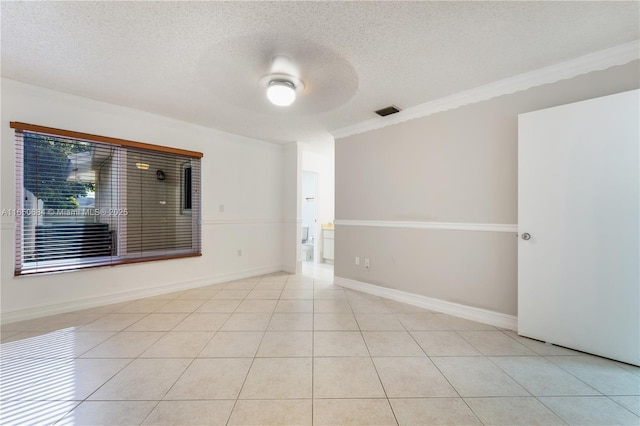 spare room featuring light tile patterned floors, visible vents, baseboards, ceiling fan, and a textured ceiling