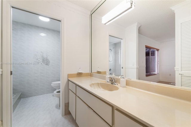 full bathroom featuring tile patterned flooring, toilet, vanity, tile walls, and a bidet